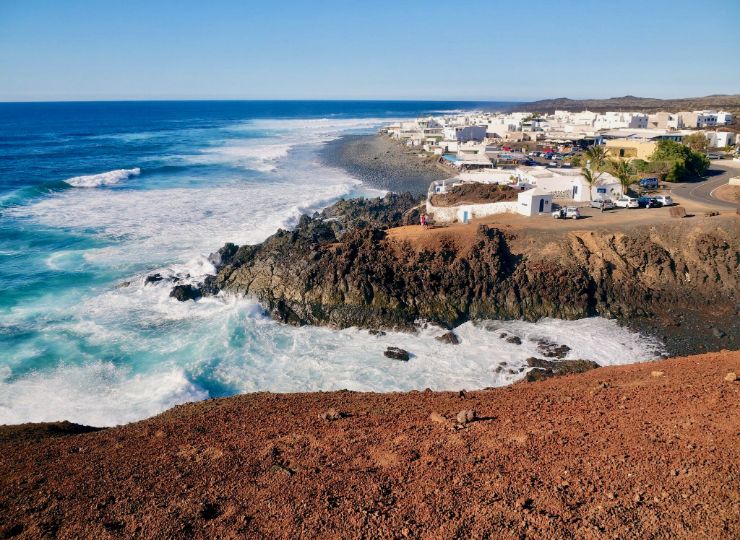 Dramatic coastline of Lanzarote with white traditional houses